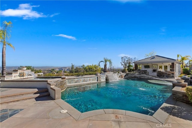 view of pool with pool water feature, an outdoor structure, and a patio