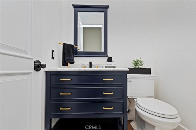 bathroom featuring toilet and vanity