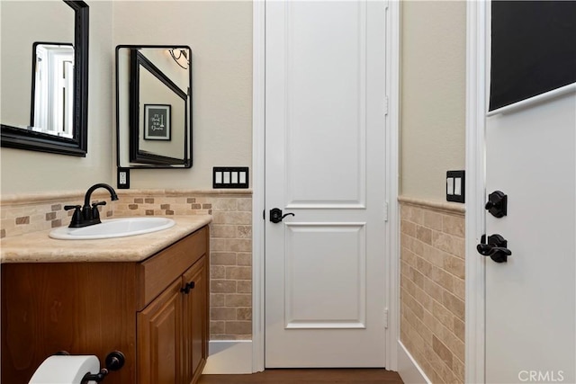 bathroom with tile walls and vanity