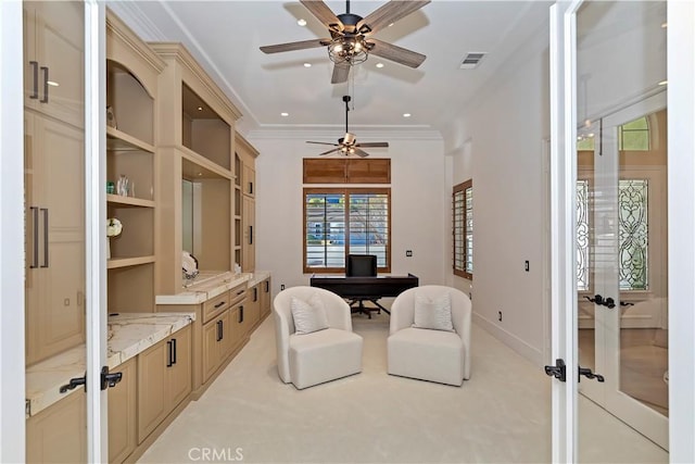 office space with ceiling fan, light colored carpet, french doors, and crown molding