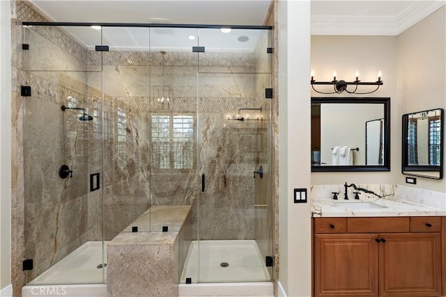 bathroom with a shower with shower door, vanity, and crown molding