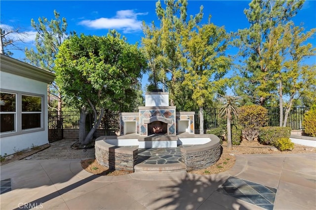 view of patio with an outdoor stone fireplace