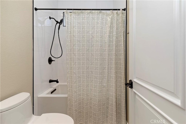 bathroom featuring toilet and shower / tub combo with curtain