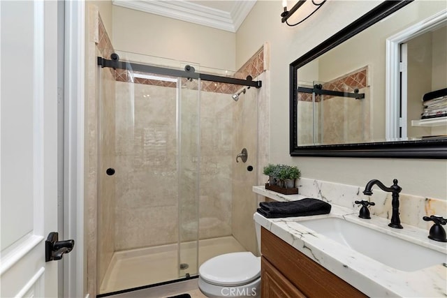 bathroom featuring toilet, ornamental molding, a shower with shower door, and vanity