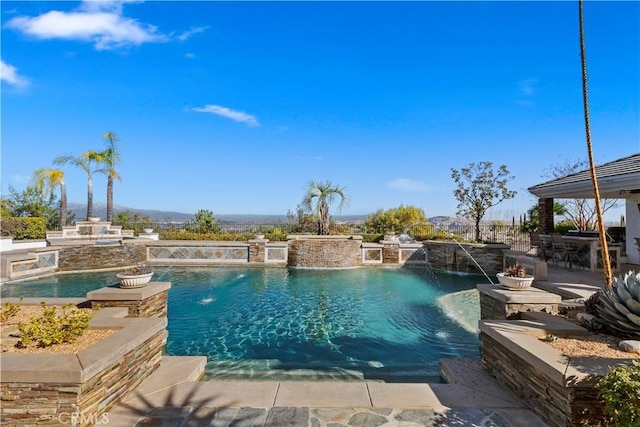 view of swimming pool with pool water feature, a hot tub, and a patio area