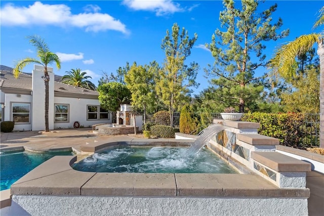 view of swimming pool featuring an in ground hot tub and a patio