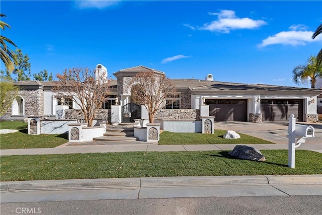 view of front of home with a front yard and a garage