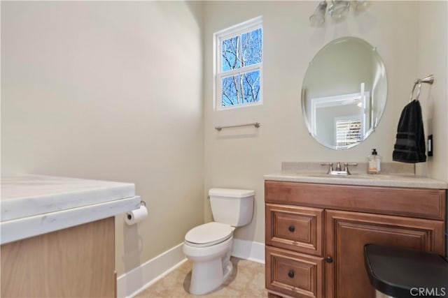 bathroom featuring toilet, vanity, and tile patterned flooring