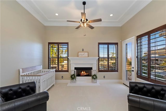 living room with carpet floors, ceiling fan, and crown molding