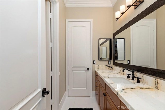 bathroom with ornamental molding, tile patterned flooring, and vanity