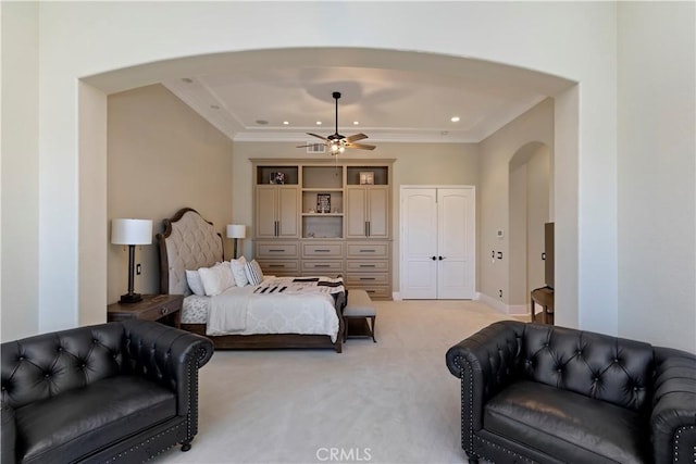 bedroom with ceiling fan, light colored carpet, and crown molding