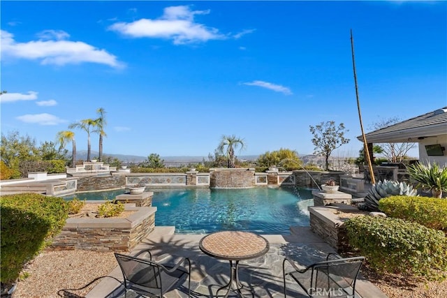 view of pool with pool water feature, a jacuzzi, and a patio area