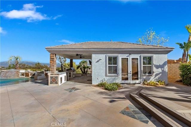 back of house featuring ceiling fan, a patio area, area for grilling, and french doors