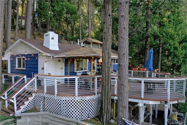 back of property featuring a wooden deck