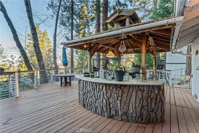 wooden deck with a gazebo and a bar