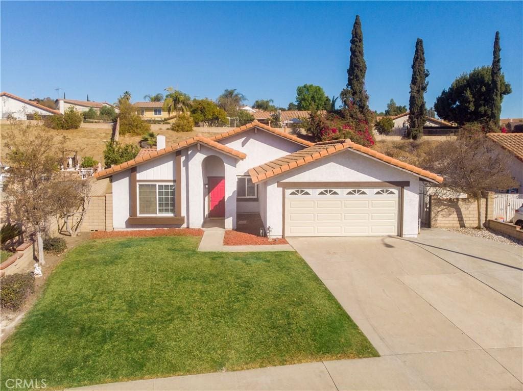 view of front of property with a front yard and a garage