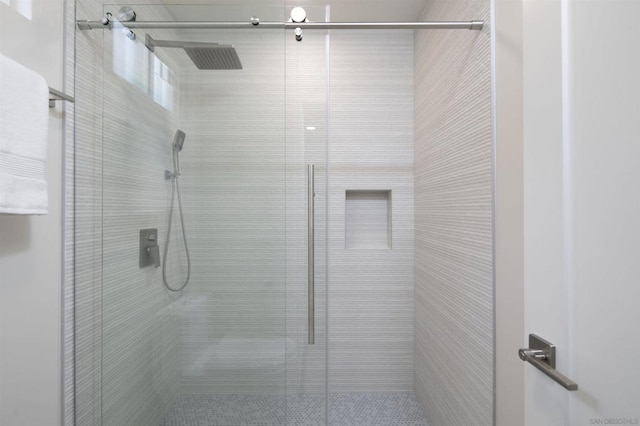 bathroom with a shower with door