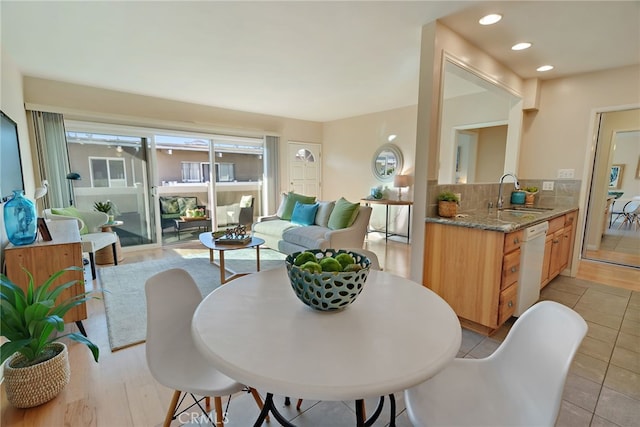 dining space with light tile patterned floors and sink