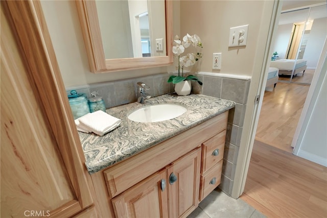 bathroom featuring wood-type flooring and vanity