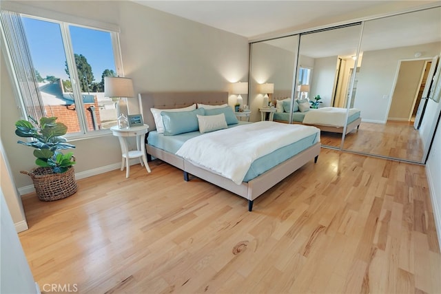 bedroom with a closet and light hardwood / wood-style flooring