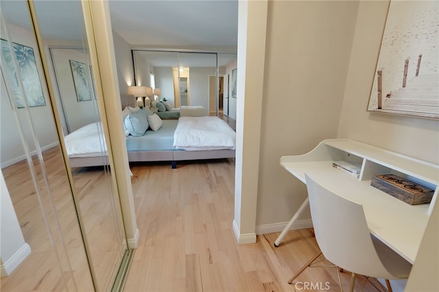 bedroom with a closet and light hardwood / wood-style flooring