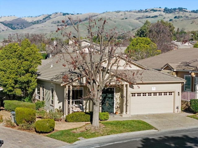 view of front of property with a garage and a mountain view