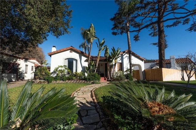 mediterranean / spanish home with a front yard