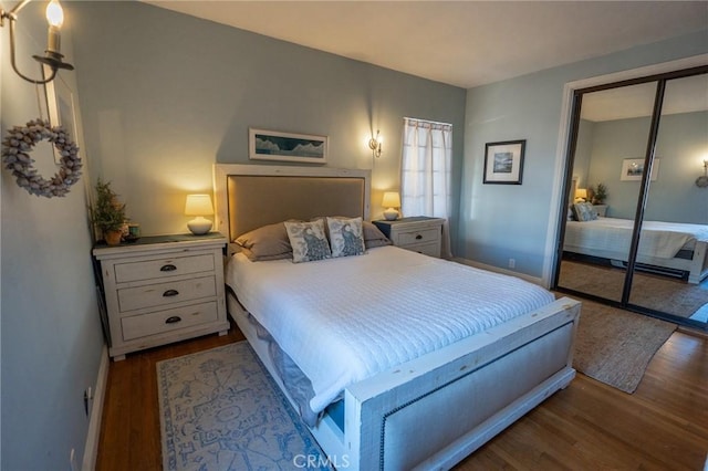 bedroom with light hardwood / wood-style floors and a closet