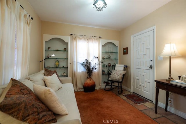 tiled living room featuring built in shelves