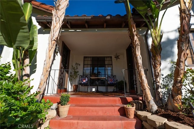 view of exterior entry featuring a porch