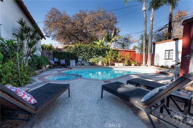 view of swimming pool with a patio area and an in ground hot tub