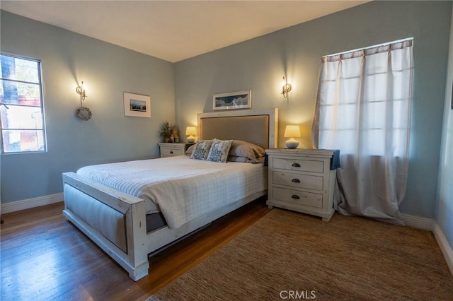 bedroom with dark wood-type flooring