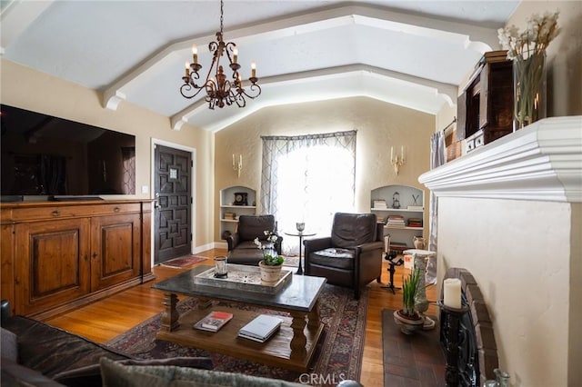 living room featuring vaulted ceiling with beams, built in features, an inviting chandelier, and dark hardwood / wood-style floors