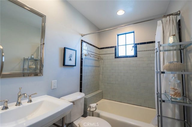 full bathroom with toilet, tiled shower / bath, and sink