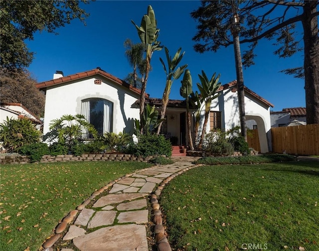 mediterranean / spanish house with a front yard