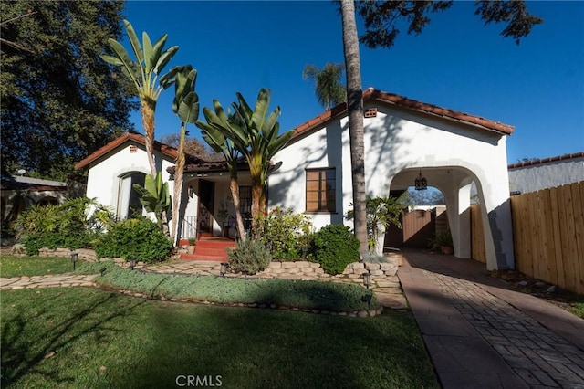 mediterranean / spanish house with a front yard