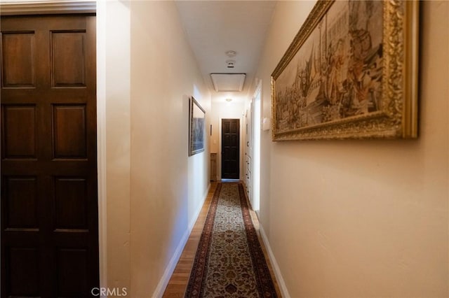 corridor with hardwood / wood-style floors