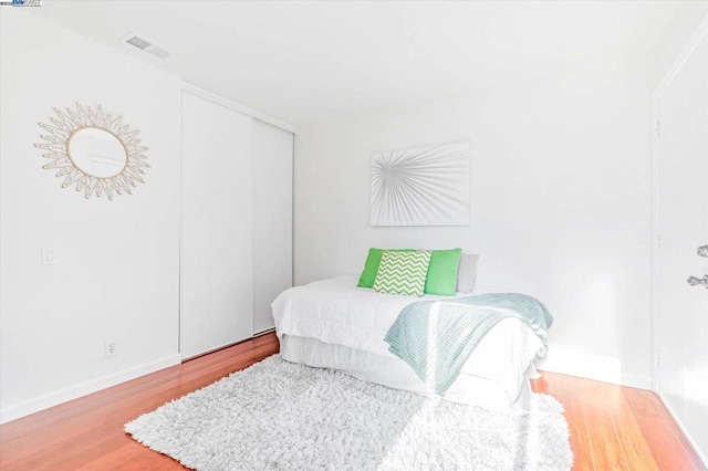 bedroom featuring a closet and hardwood / wood-style floors