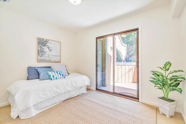 bedroom with carpet and access to exterior