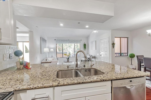 kitchen with stainless steel appliances, wood-type flooring, light stone countertops, white cabinets, and sink