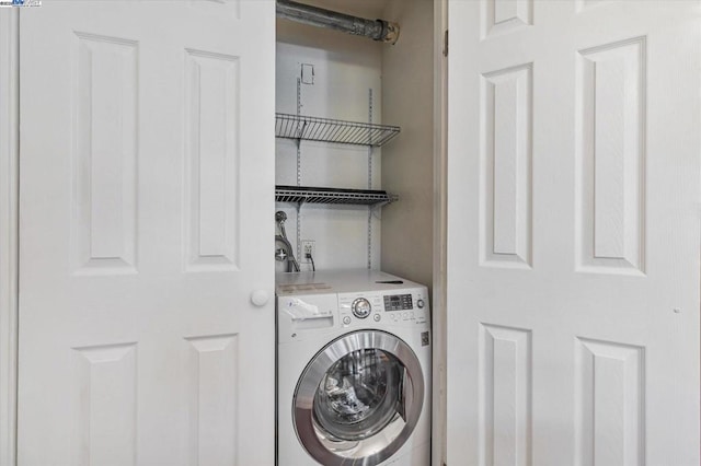 clothes washing area featuring washer / dryer