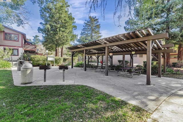 view of community with a pergola and a yard