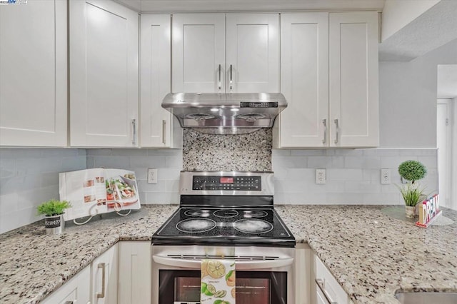 kitchen with electric stove, backsplash, white cabinets, and ventilation hood