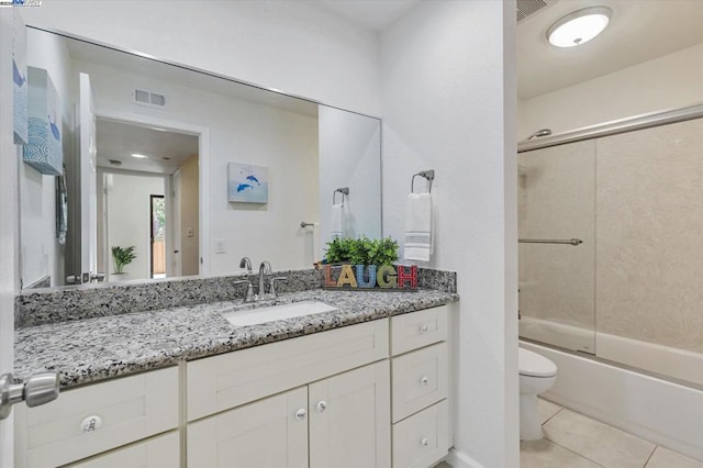 full bathroom with tile patterned floors, shower / bath combination with glass door, vanity, and toilet