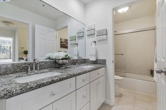 full bathroom with vanity, toilet, bath / shower combo with glass door, and tile patterned flooring