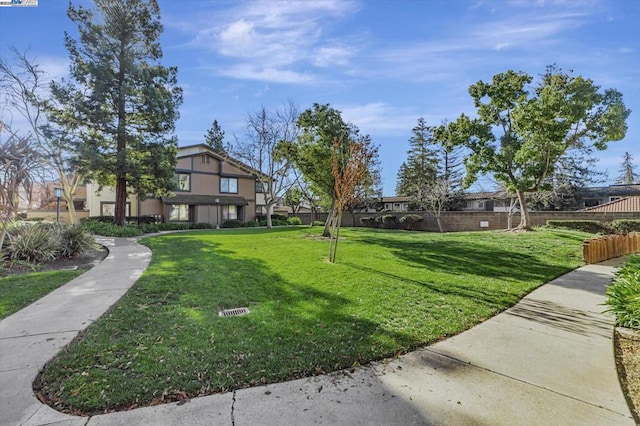 view of property's community with a yard