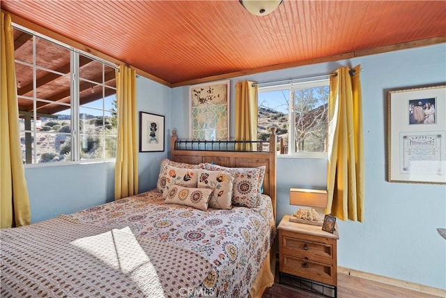 bedroom featuring hardwood / wood-style flooring and multiple windows