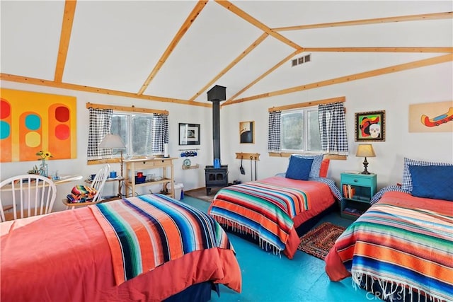 bedroom featuring lofted ceiling, a wood stove, and multiple windows