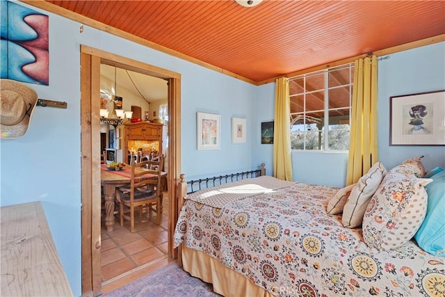 tiled bedroom featuring wood ceiling