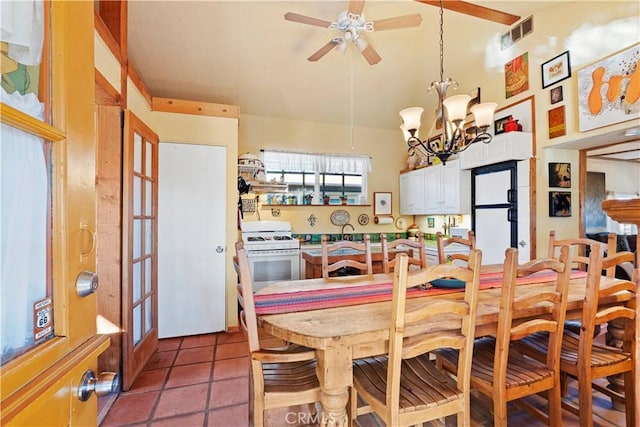 dining area with ceiling fan with notable chandelier and tile patterned floors